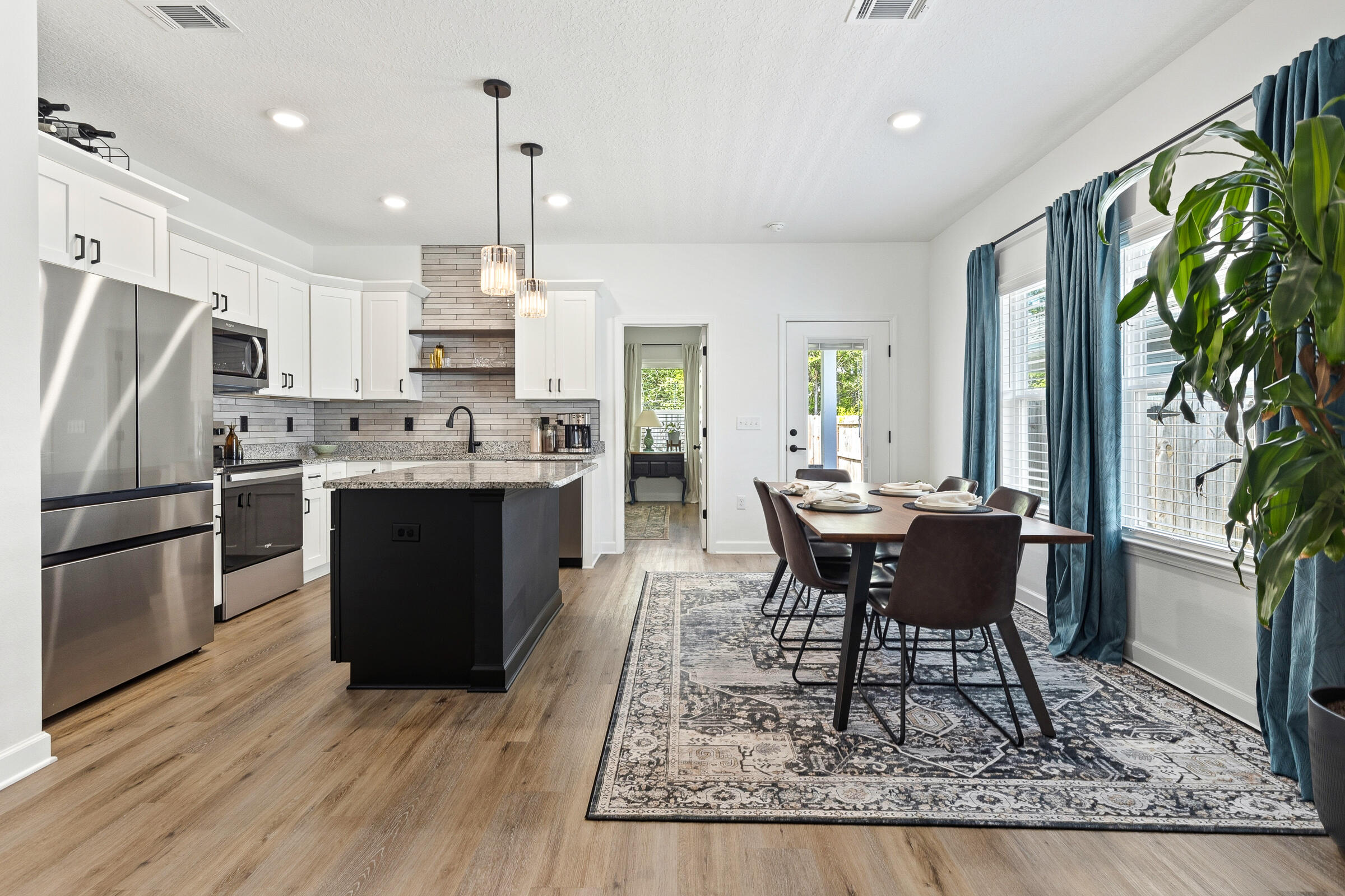 65 Marsh Landing North Freeport, FL 32439 - Photo 3 of 35 a living room with stainless steel appliances granite countertop furniture wooden floor and a kitchen view