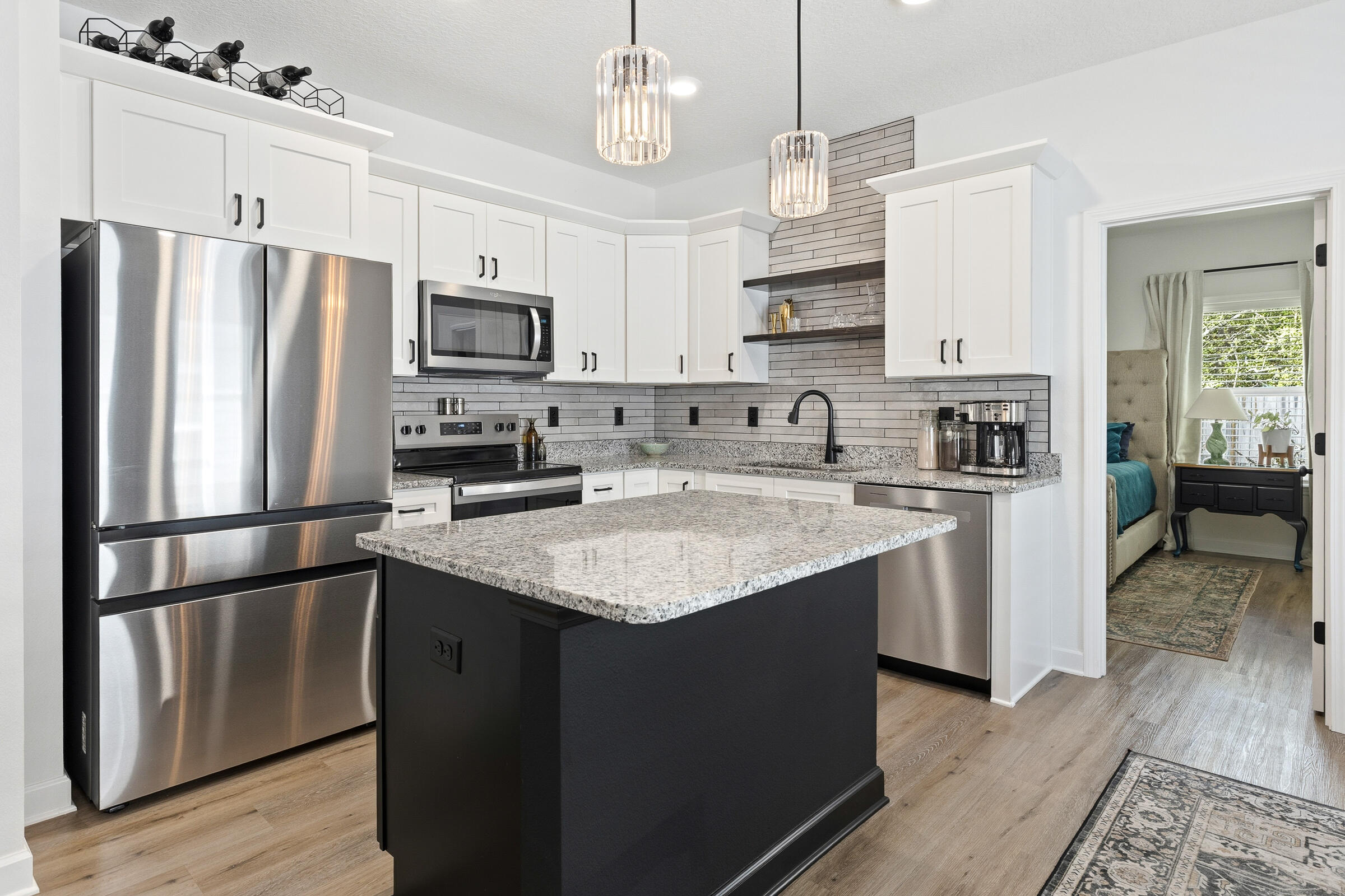 65 Marsh Landing North Freeport, FL 32439 - Photo 7 of 35 a kitchen with stainless steel appliances granite countertop a refrigerator a sink dishwasher a stove top oven a kitchen island and cabinets with wooden floor