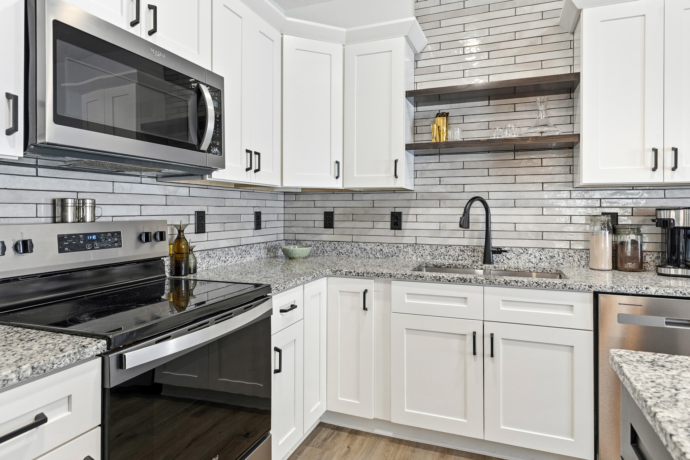 65 Marsh Landing North Freeport, FL 32439 - Photo 9 of 35 a kitchen with stainless steel appliances granite countertop a sink stove and microwave