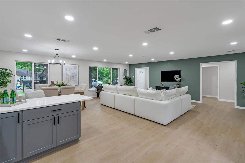 4815 Kelman Street Dallas, TX 75214 - Photo 14 of 37 Open-concept living space featuring wood-finish flooring, recessed lighting, and large windows