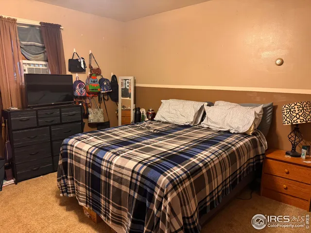 a bedroom with a bed and dresser
