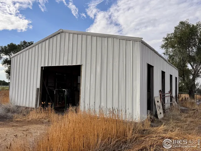 a view of a house with a wooden fence