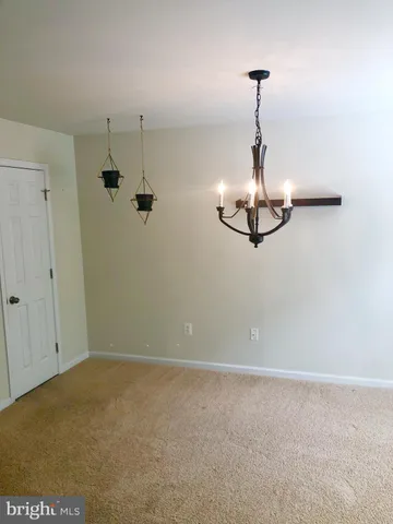 a view of a room with a hanging light
