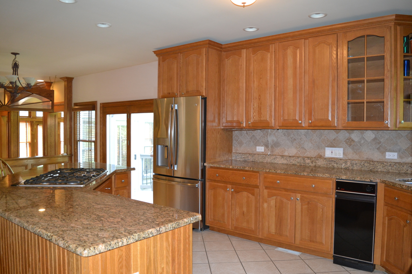 9N313 Muirhead Road Elgin, IL 60124 - Photo 11 of 61 a kitchen with stainless steel appliances granite countertop a refrigerator a stove and a sink with wooden cabinets