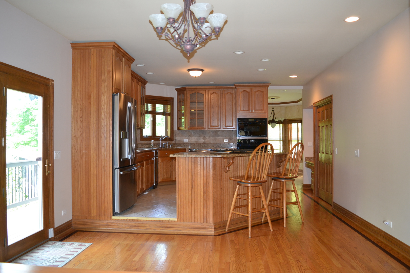 9N313 Muirhead Road Elgin, IL 60124 - Photo 9 of 61 a view of a dining room with furniture a chandelier and wooden floor