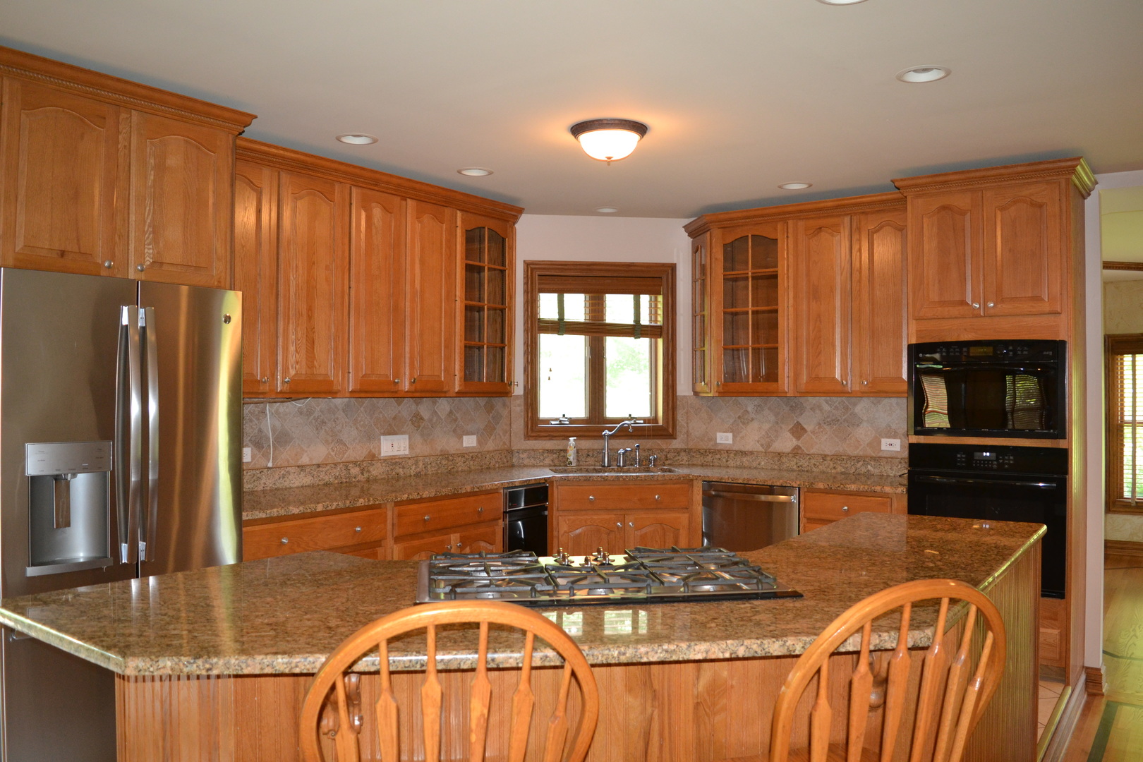 9N313 Muirhead Road Elgin, IL 60124 - Photo 10 of 61 a kitchen with kitchen island granite countertop a sink stove and refrigerator
