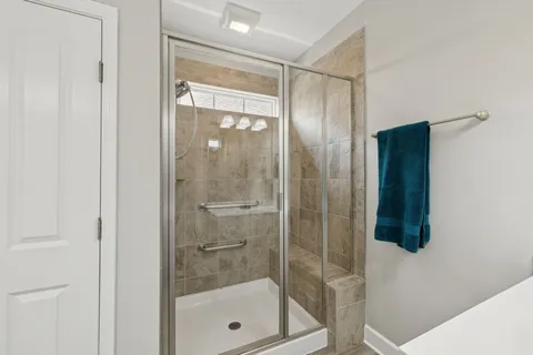 a bathroom with a glass shower door