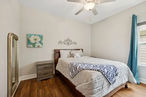 a bedroom with a bed and a chandelier
