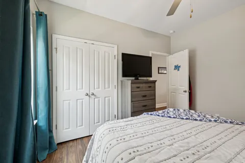 a bedroom with a bed and a flat screen tv