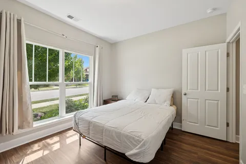 a bedroom with a bed and a large window