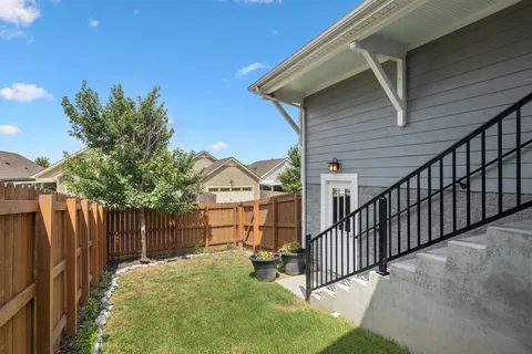 a view of a house with wooden fence