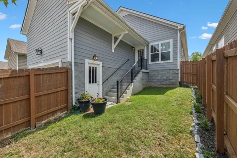 a backyard of a house with wooden floor and fence