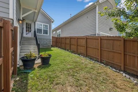a backyard of a house with wooden fence