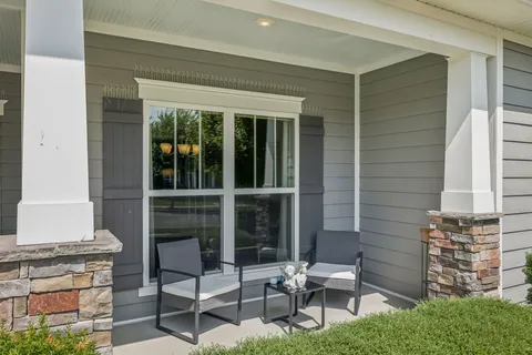 a view of a patio with table and chairs and potted plants