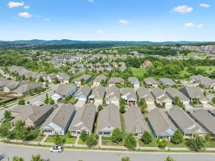 an aerial view of residential houses with outdoor space and street view