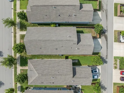 an aerial view of a house with a yard