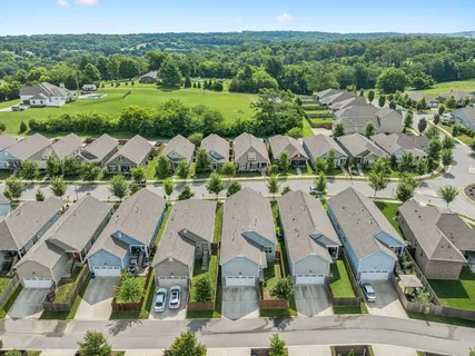 an aerial view of residential houses with outdoor space and street view