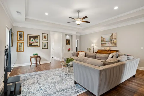 a living room with furniture and wooden floor