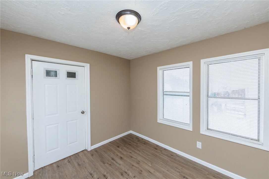 5062 Lee Road Maple Heights, OH 44137 - Photo 21 of 50 Empty room featuring a textured ceiling and light wood-style flooring