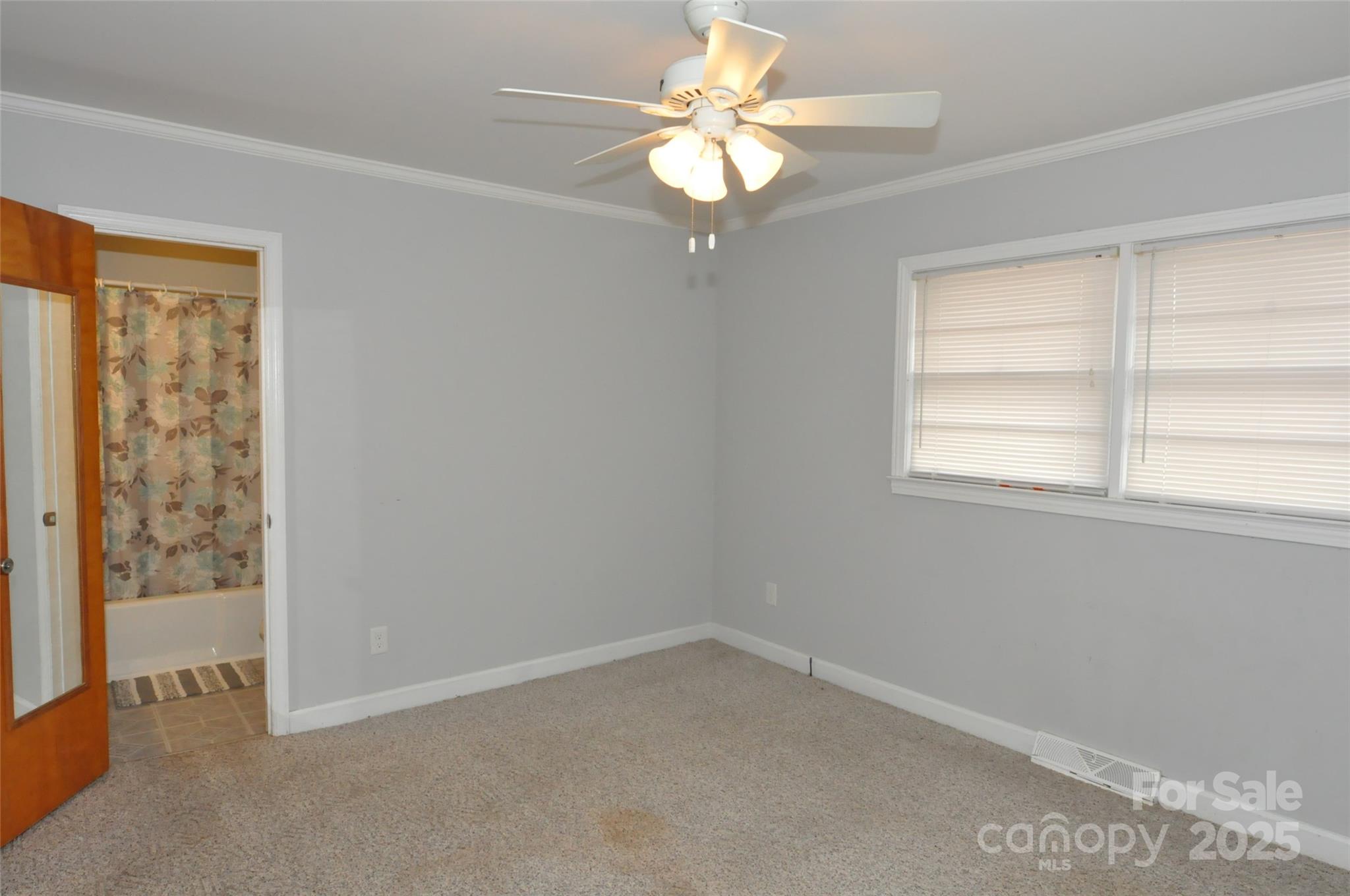 378 Center Street, Unit 1 Chester, SC 29706 - Photo 17 of 28 an empty room with windows and fan