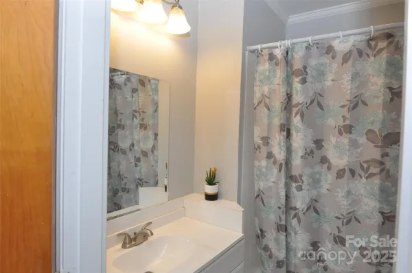 a bathroom with a shower curtain and a sink