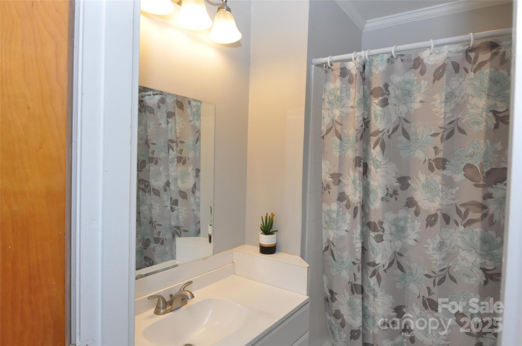 378 Center Street, Unit 1 Chester, SC 29706 - Photo 18 of 28 a bathroom with a shower curtain and a sink