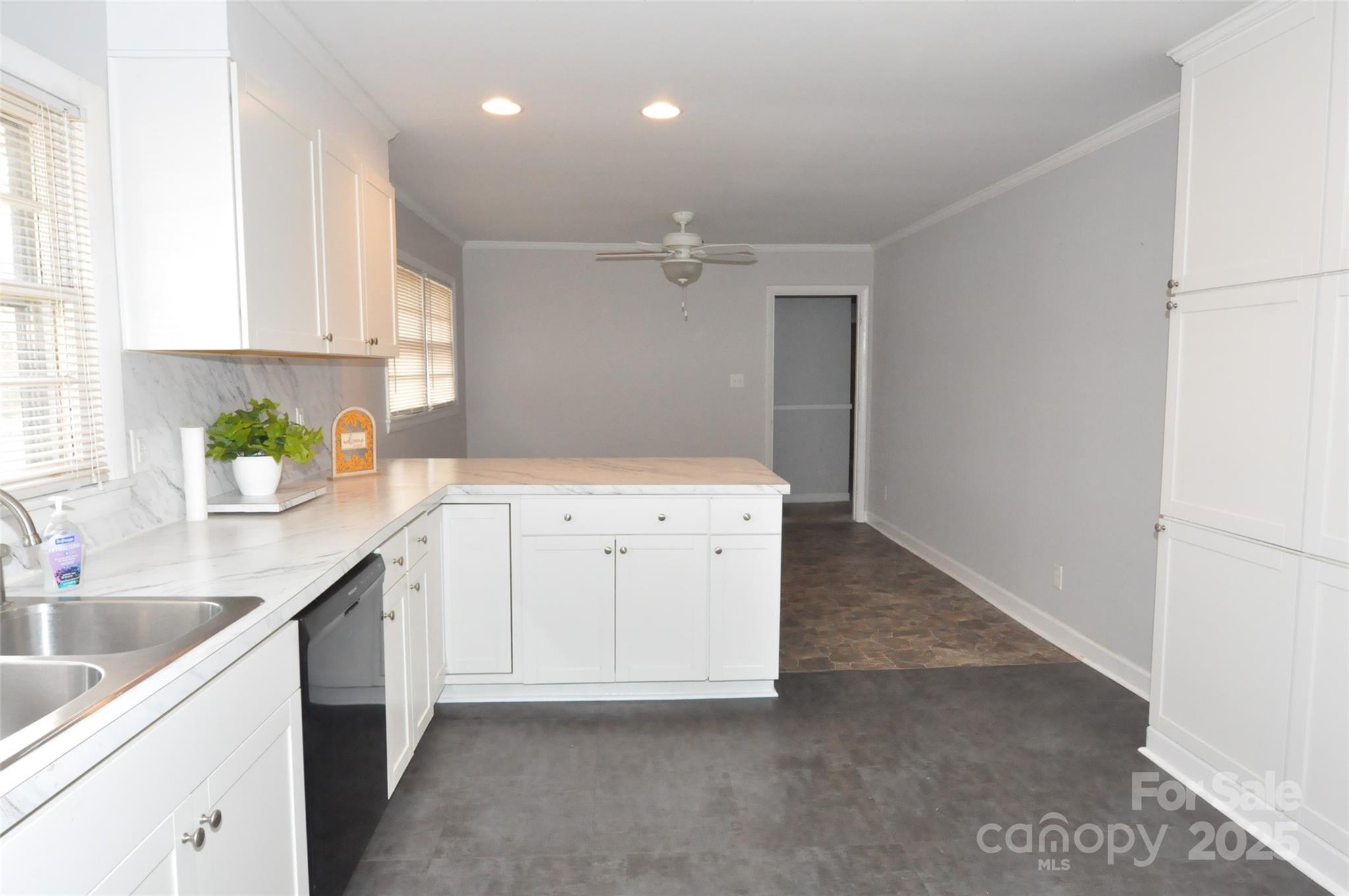 378 Center Street, Unit 1 Chester, SC 29706 - Photo 2 of 28 a kitchen with a sink dishwasher and white cabinets with wooden floor