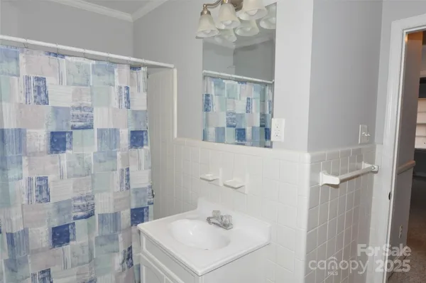 a bathroom with a sink a mirror and shower