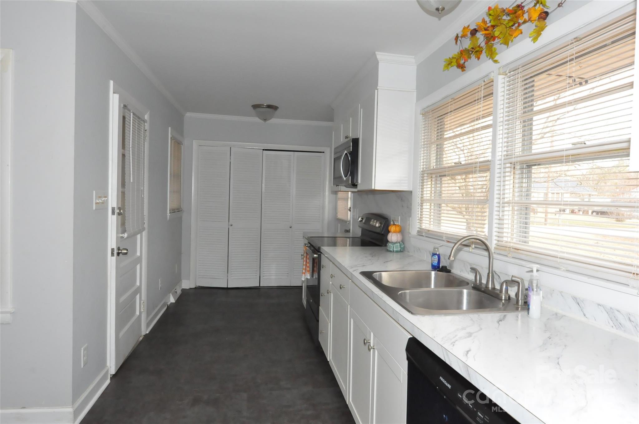 378 Center Street, Unit 1 Chester, SC 29706 - Photo 3 of 28 a kitchen with granite countertop a sink stove and cabinets