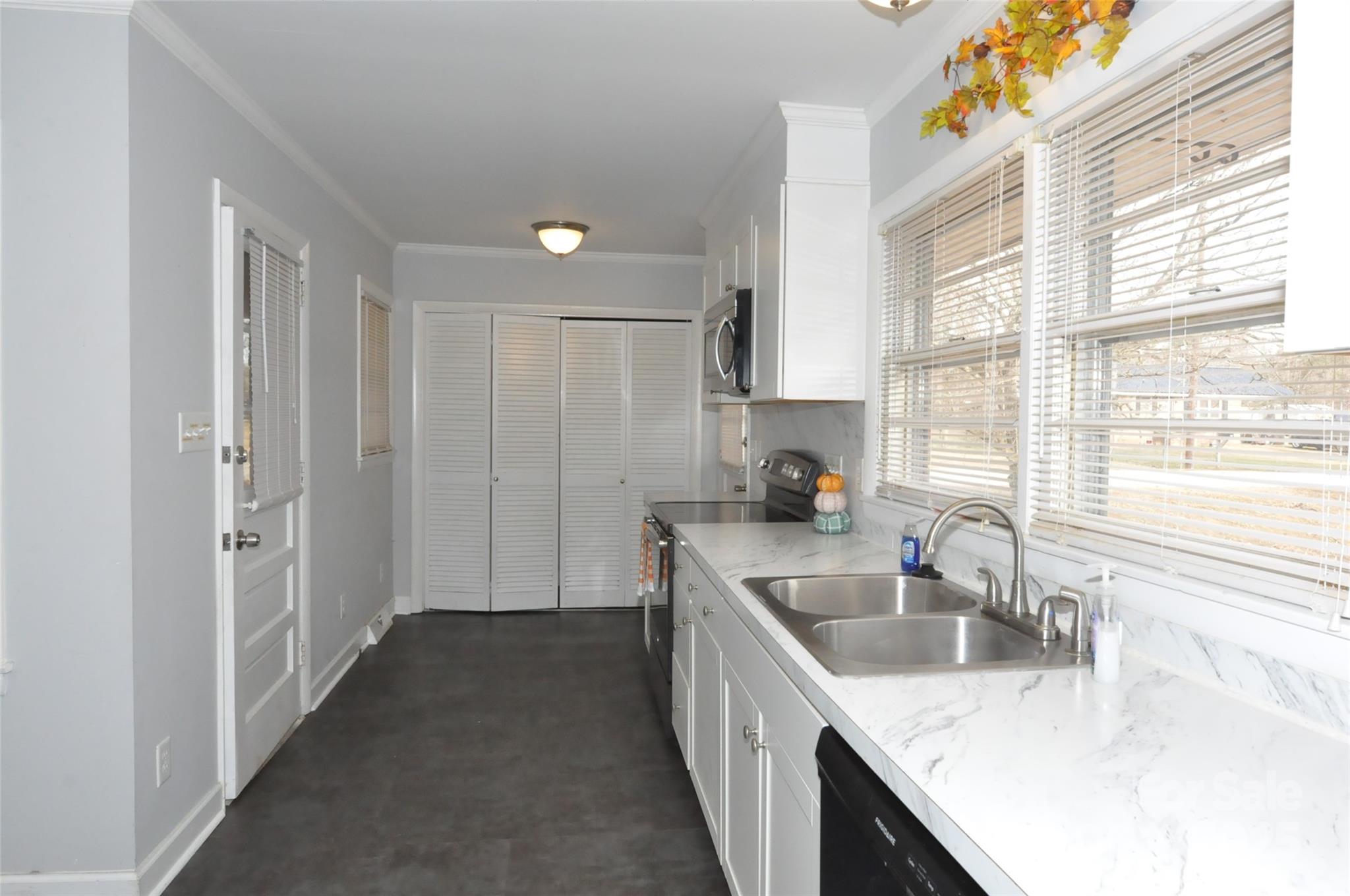 378 Center Street, Unit 1 Chester, SC 29706 - Photo 4 of 28 a kitchen with granite countertop a sink stove and cabinets