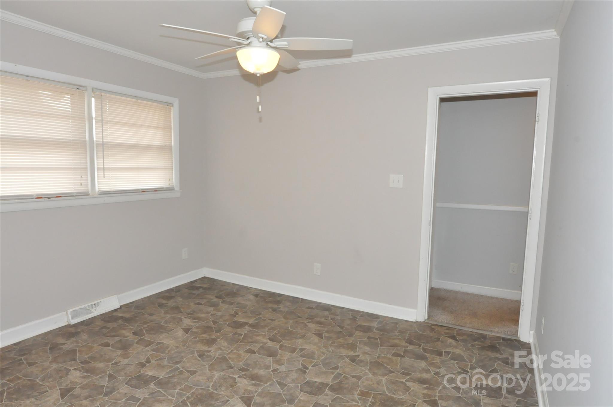 378 Center Street, Unit 1 Chester, SC 29706 - Photo 7 of 28 an empty room with a window and ceiling fan