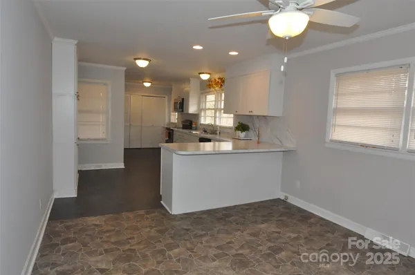 a view of kitchen with center island and stainless steel appliances