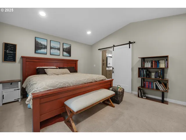 a bedroom with a bed and a bookshelf