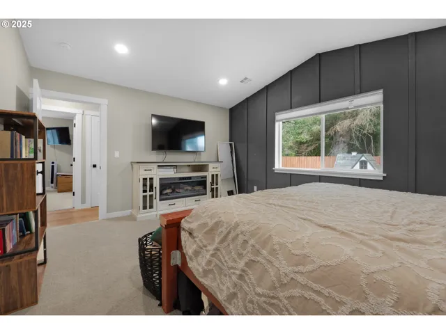 a bedroom with a bed and a flat screen tv