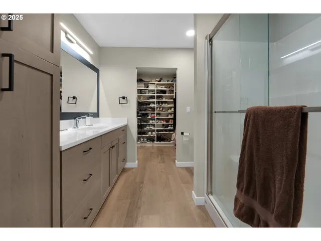a bathroom with a double vanity sink a toilet and a tub