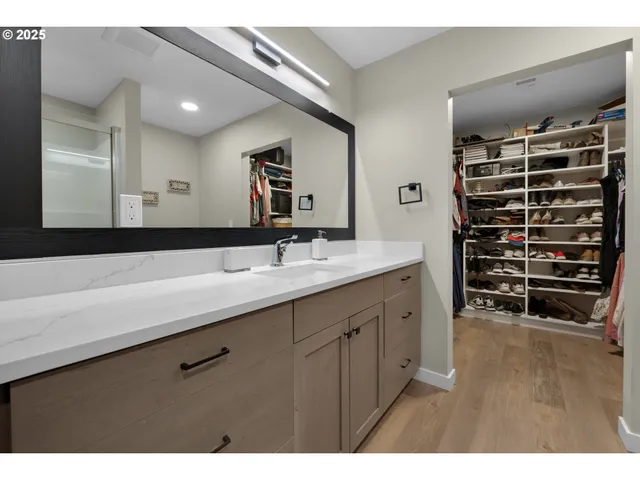 a bathroom with a double vanity sink and a large mirror