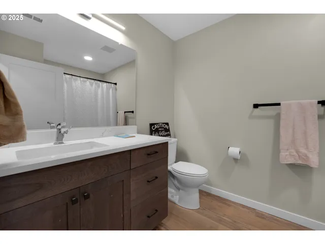 a bathroom with a sink toilet a mirror and vanity