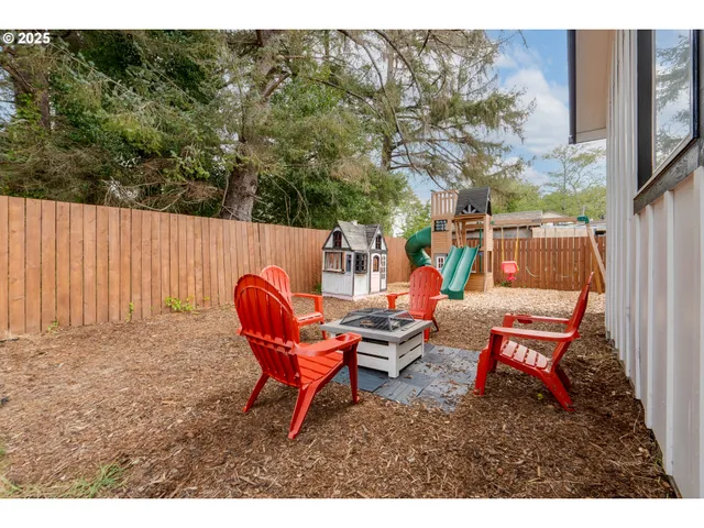 a backyard of a house with table and chairs