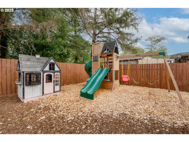 a view of a house with a yard and sitting area