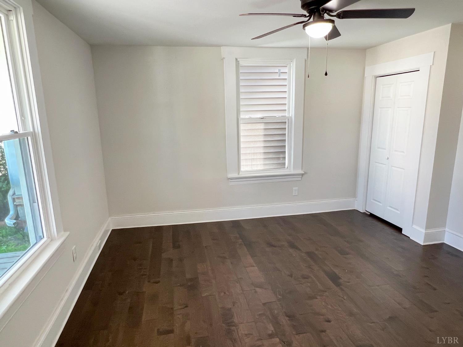 2927 Langhorne Road Lynchburg, VA 24501 - Photo 14 of 19 an empty room with wooden floor fan and windows