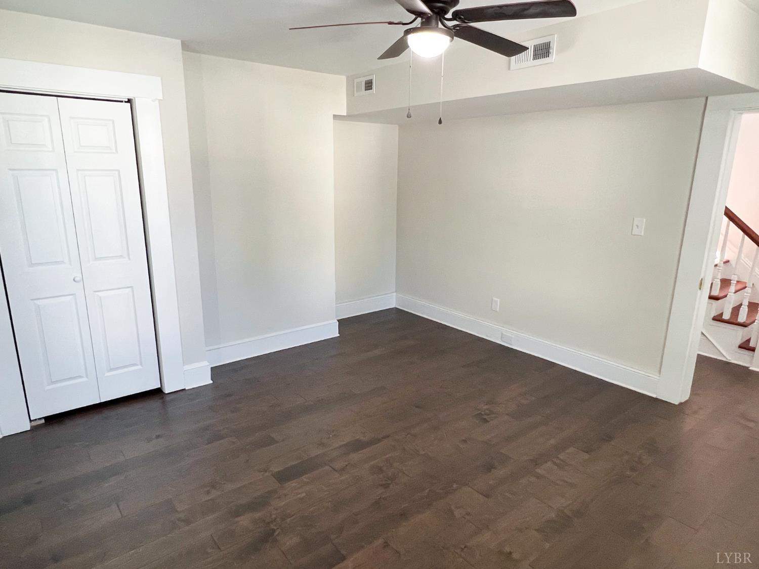 2927 Langhorne Road Lynchburg, VA 24501 - Photo 15 of 19 an empty room with wooden floor fan and windows