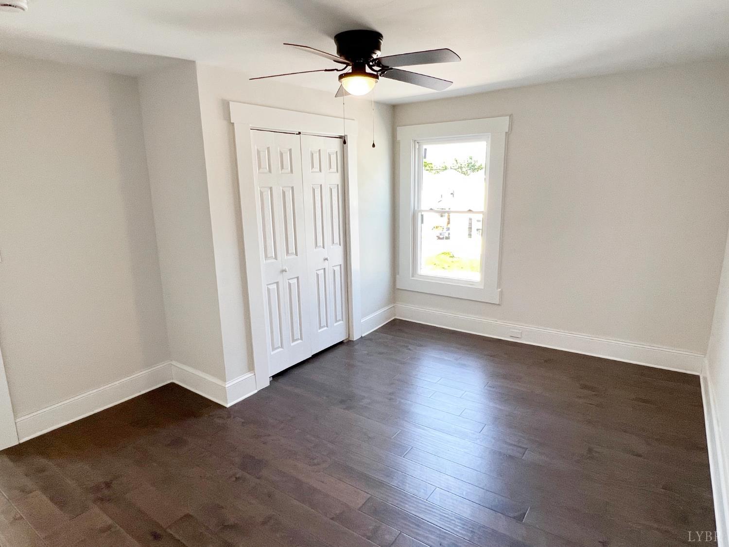2927 Langhorne Road Lynchburg, VA 24501 - Photo 18 of 19 an empty room with wooden floor ceiling fan and windows
