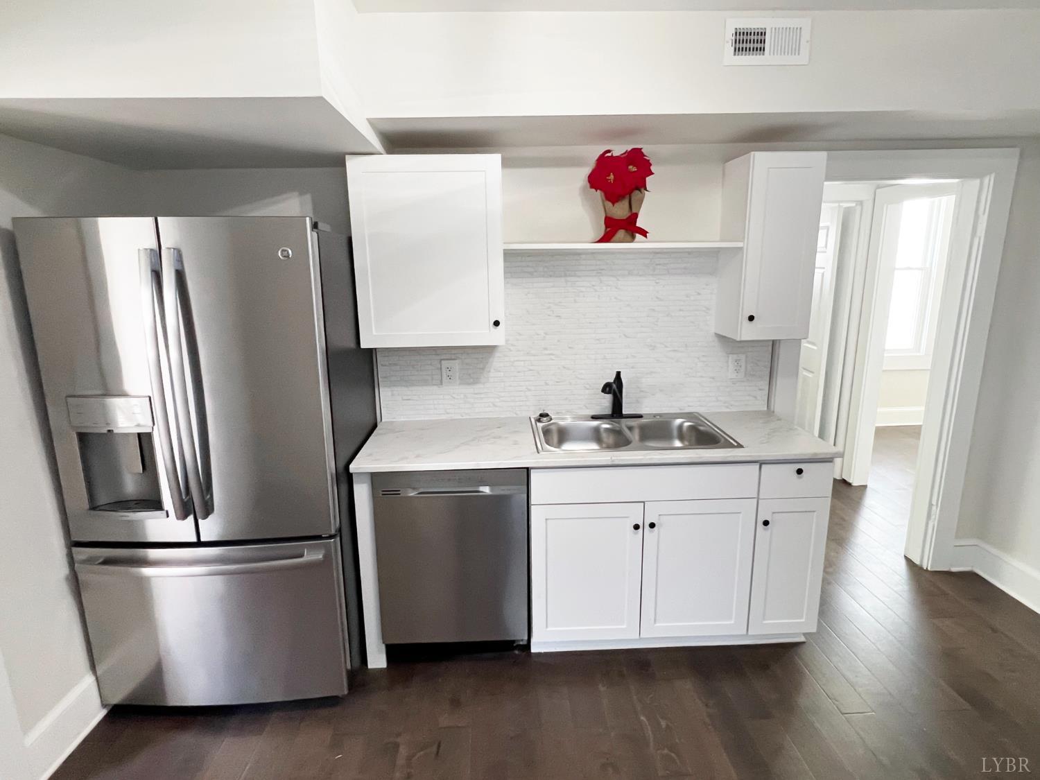 2927 Langhorne Road Lynchburg, VA 24501 - Photo 8 of 19 a kitchen with stainless steel appliances a refrigerator a sink and wooden floors