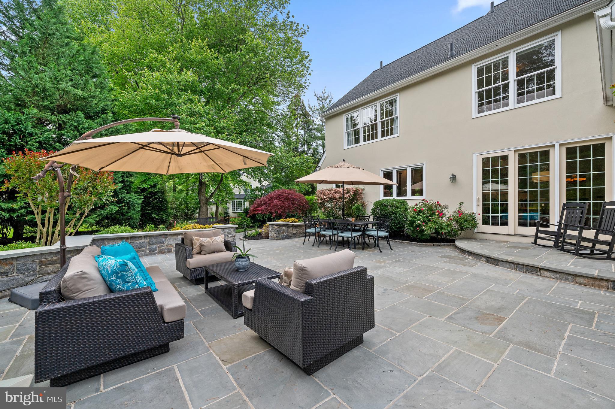 704 Turnbridge Road Wayne, PA 19087 - Photo 56 of 64 a view of a patio with couches table and chairs under an umbrella