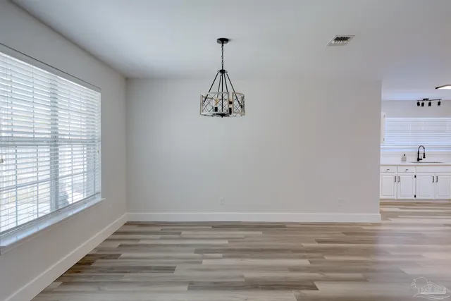 a view of a room with window and wooden floor