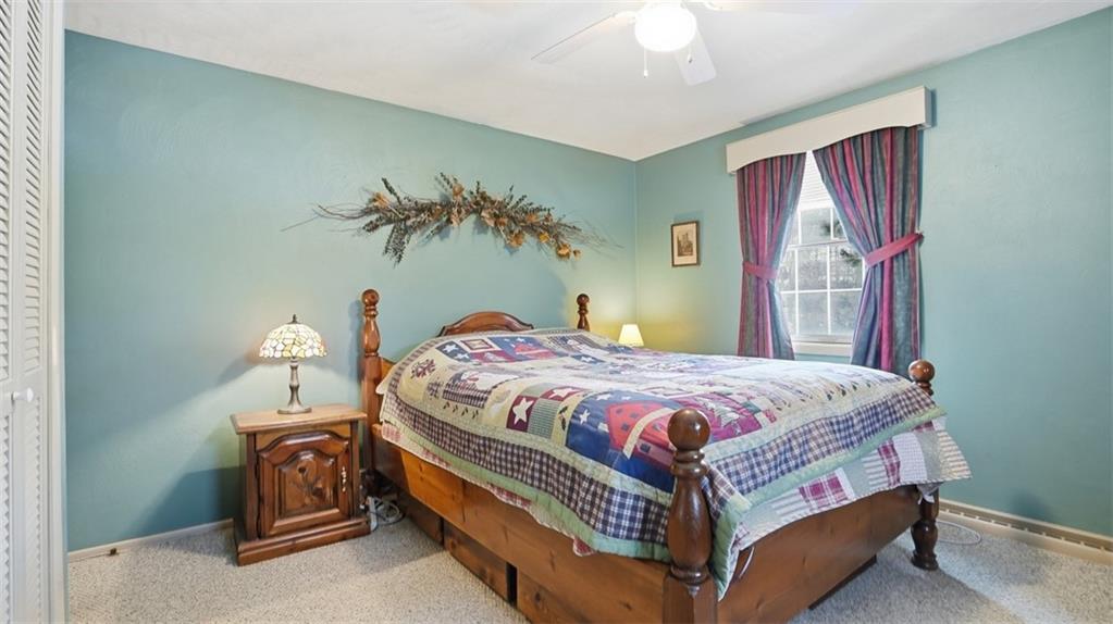 6142 Penn Drive Butler, PA 16002 - Photo 17 of 34 a bedroom with a bed and a chandelier