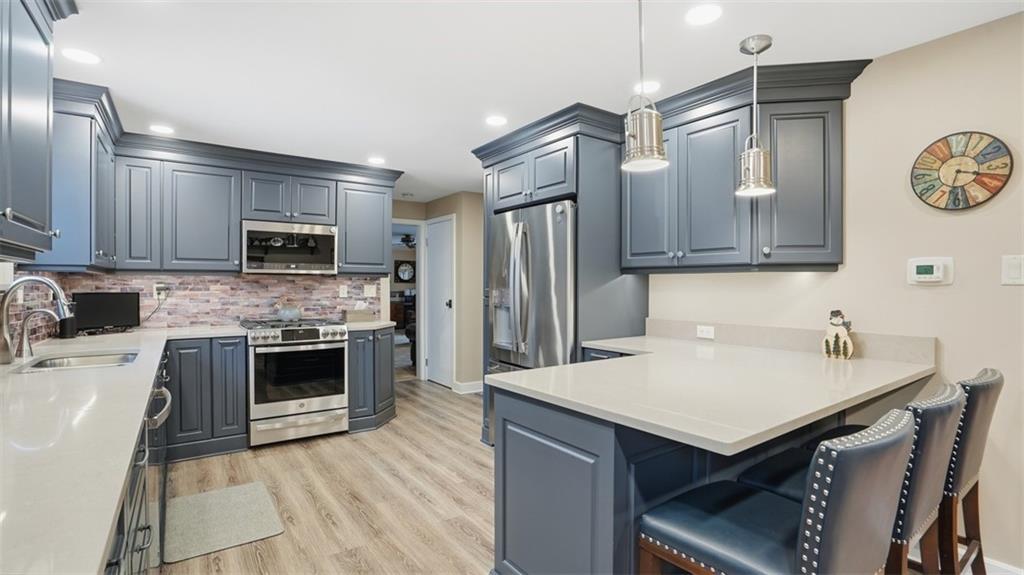 6142 Penn Drive Butler, PA 16002 - Photo 9 of 34 a kitchen with granite countertop a sink stove and refrigerator