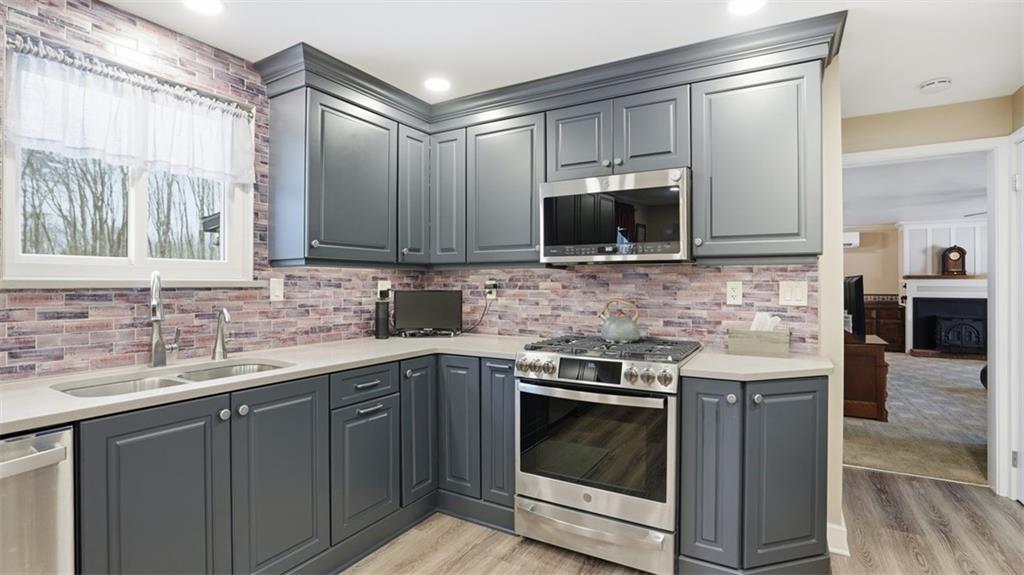 6142 Penn Drive Butler, PA 16002 - Photo 10 of 34 a kitchen with a stove microwave and sink