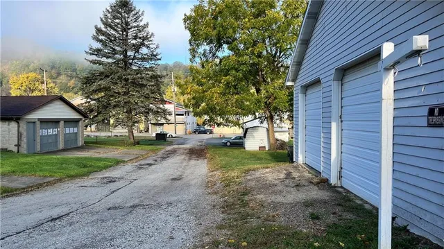 a view of a house with a yard and pathway