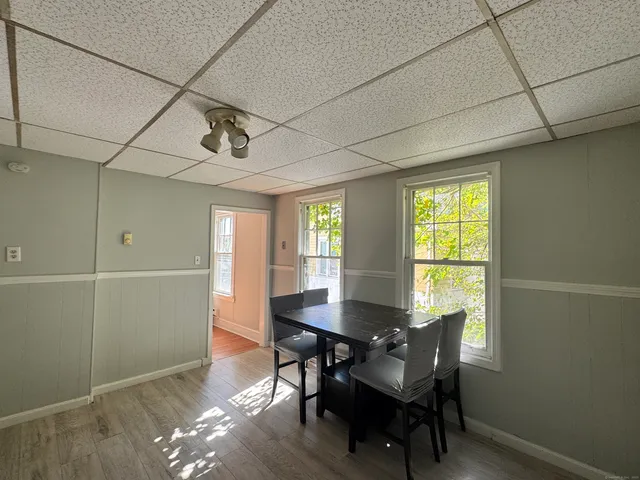 a view of a dining room with furniture and window